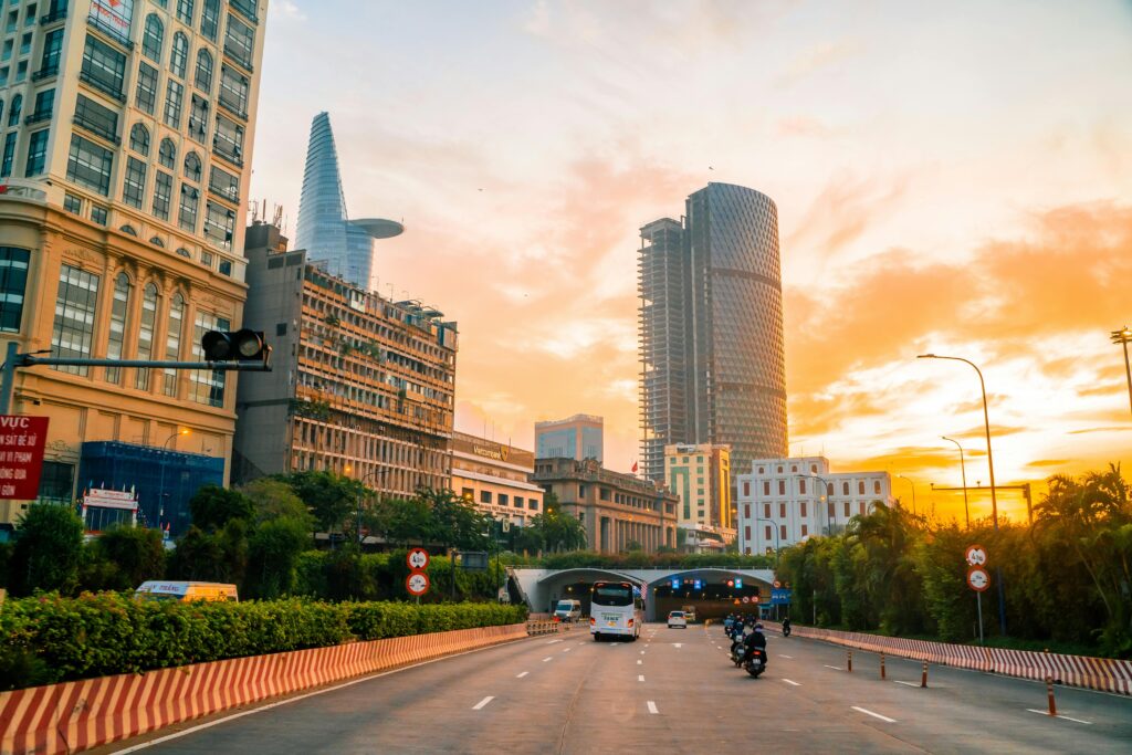 Vibrant sunset over Ho Chi Minh City's modern skyline and busy roads.